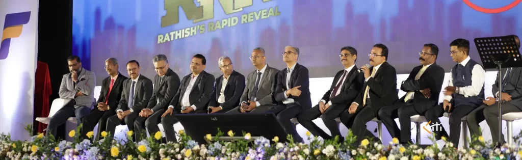 Panelists lined up on stage engaged in a panel discussion during a business convention.