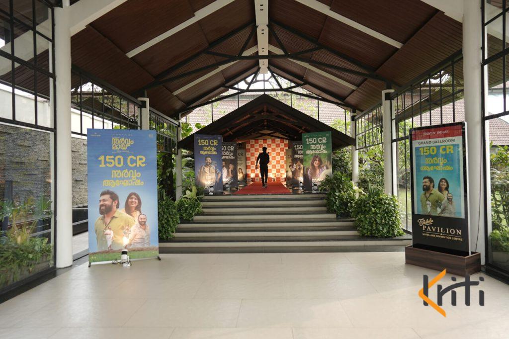 Covered walkway hall decorated with promotional event banners and stairway setup by Kriti Events