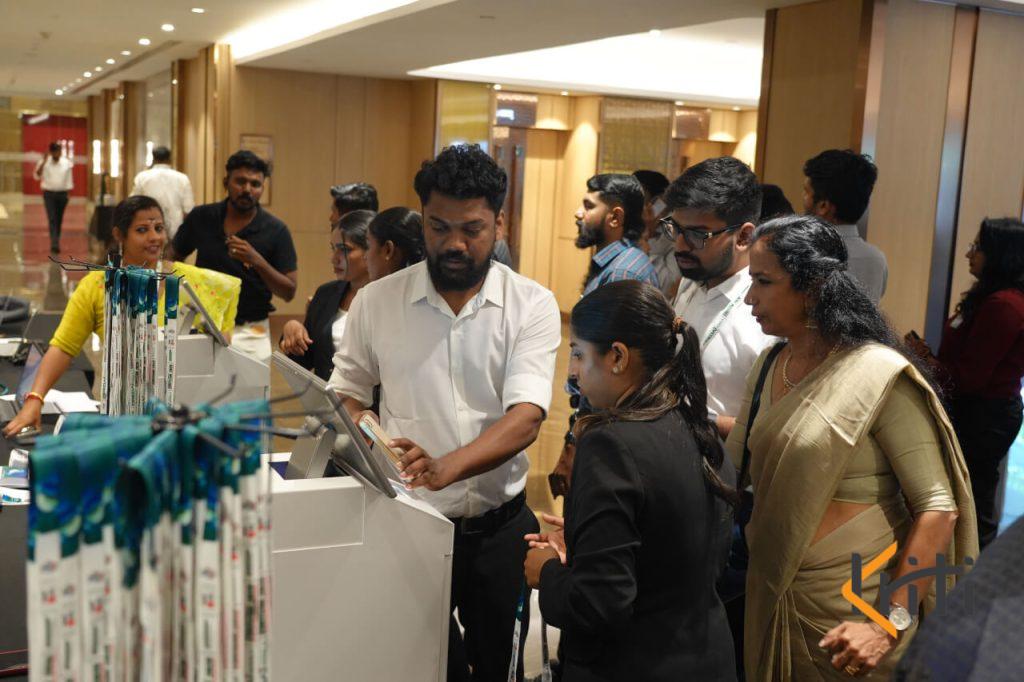 Crowd of attendees gathering at the check-in desk for event registration and lanyard pickup by Kriti Events