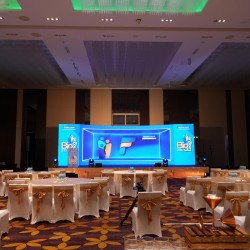 Elegant corporate event banquet hall setup and stage lighting by Kriti Events